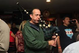 A bagpiper playing for the crowd at Trinity Pub