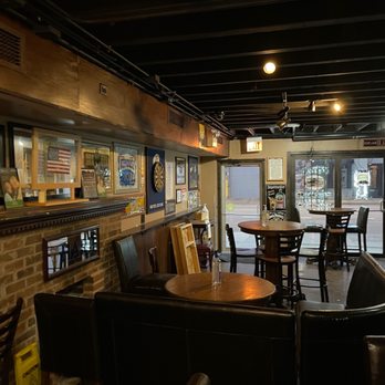 Inside Trinity Pub: leather booths, high-top tables, sports memorabilia and the dart board